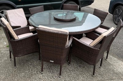 Lot 160 - A circular glass topped garden table and eight...