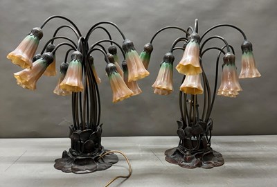 Lot 159 - A pair of Tiffany style glass and bronze lily...