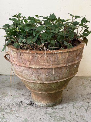 Lot 233 - A large terracotta planter with handles and...
