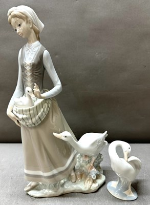 Lot 322 - Two Lladro porcelain figures One woman with...
