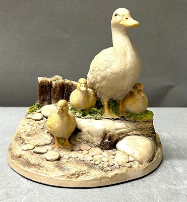 Lot 701 - A resin figure of a mother duck and ducklings
