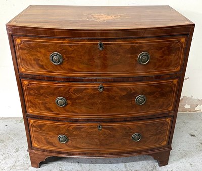 Lot 13 - An bow front chest of drawers featuring...