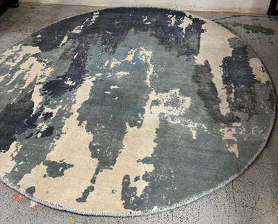 Lot 427 - Around wool rug colours featured are dark blue,...