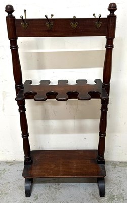 Lot 70 - A mahogany boot rack featuring turned finials...