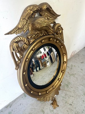 Lot 48 - A Regency style bullseye mirror featuring...