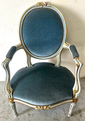 Lot 50 - A blue velvet armchair with carved giltwood...