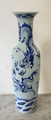 Lot 383 - A tall Chinese vase with blue and white dragon...