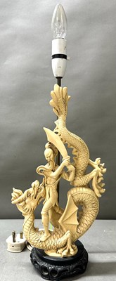 Lot 64 - A table lamp featuring an Asian dragon slayer...
