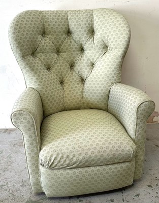 Lot 125 - A high back armchair with a distinct green...