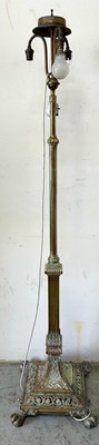 Lot 264 - A brass standing lamp featuring a decorative...