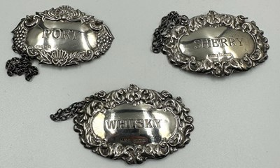 Lot 494 - Three sterling silver decanter labels, all...