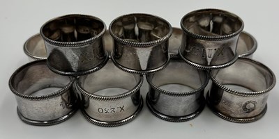 Lot 496 - A set of eleven EPNS napkin rings