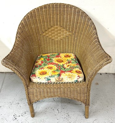 Lot 55 - A rattan Loom chair with a floral patterned...