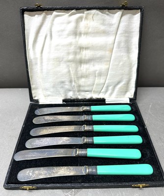 Lot 700 - A set of six EPNS butter knives with green...