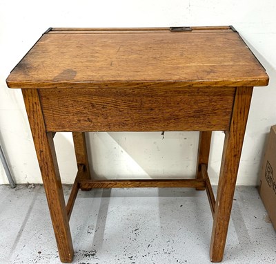 Lot 59 - A vintage oak school desk with a hinged lift...