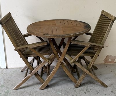 Lot 21 - A teak garden table and two folding teak chairs