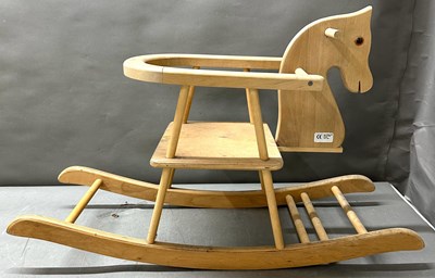 Lot 642 - A wooden rocking horse featuring a seat and a...