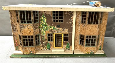 Lot 645 - A vintage doll's house featuring pressed metal...