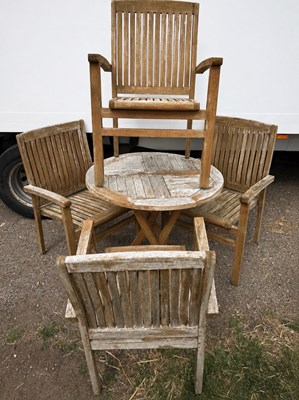 Lot 242 - A weathered round table and four matching four...
