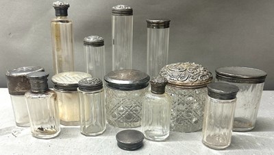 Lot 445 - A collection of vanity jars and bottles with...