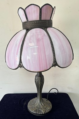 Lot 260 - A pink Tiffany-style table lamp features a...