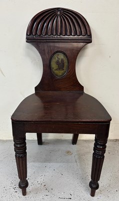 Lot 96 - A Regency mahogany hall chair features a...