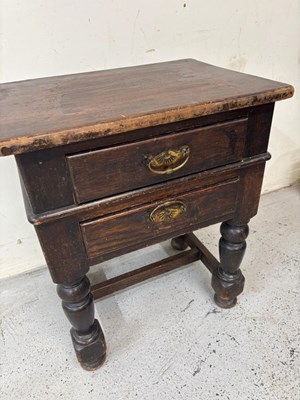 Lot 97 - A dark wood end table features two drawers...