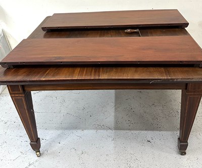 Lot 429A - A mahogany extendable dining table with...