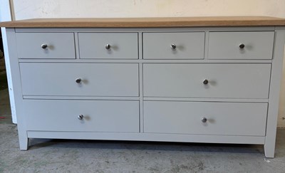Lot 151 - A long chest of drawers featuring four short...