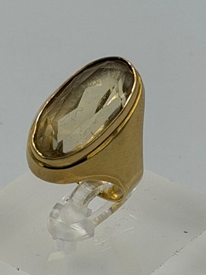 Lot 564 - A 9ct gold citrine style cocktail ring with an...