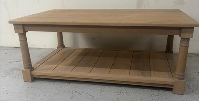 Lot 87 - An oak coffee table on turned legs and a lower...