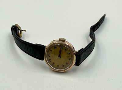 Lot 555 - A Finnigans 9ct gold Ladies watch on leather...