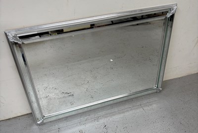Lot 251 - A modern mirror in silver frame with leaf...