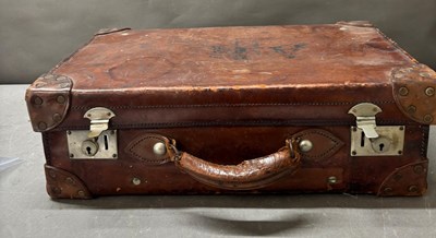 Lot 808 - Antique leather suitcase features riveted...