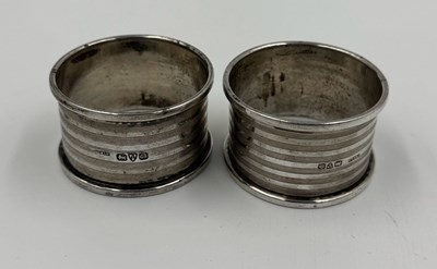 Lot 476 - Two hallmarked silver napkin rings with an...
