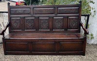 Lot 201 - An 18th-century oak settle with a lift-up seat...