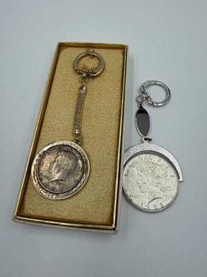 Lot 580 - A 1923 Morgan dollar and a 1964 Half dollar as...