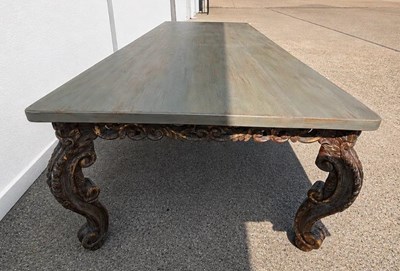 Lot 200 - A large dining table in a French style with a...