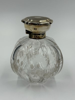 Lot 465 - A large silver topped scent bottle with floral...