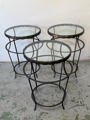 Lot 142 - A trio of glass and metal side tables H61cm...
