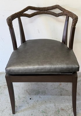 Lot 107 - Dark wood armchair features a braided leather...