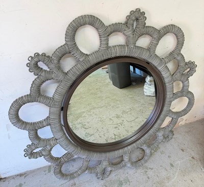 Lot 254 - Circular wall mirror features a braided rope...