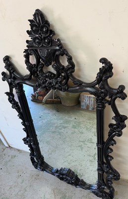 Lot 252 - Ornate black wall mirror in a baroque style...