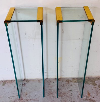 Lot 128 - Two glass and metal narrow side tables H73cm...