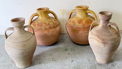 Lot 365 - Three rustic terracotta jugs or vessell